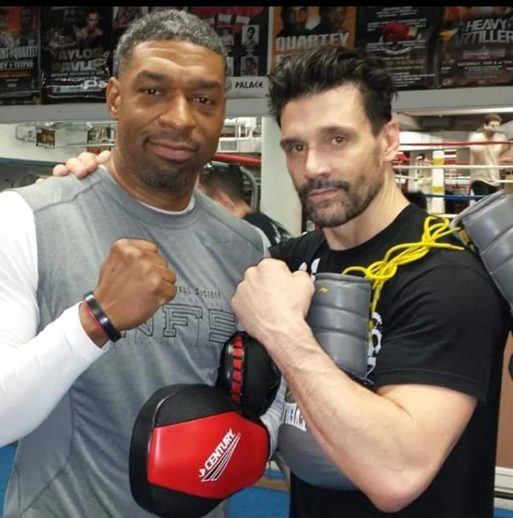 Smiley at a boxing gym with a fellow boxer