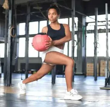 Athlete performing a medicine-ball lunge
