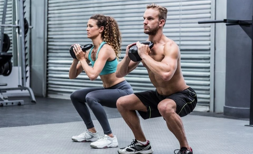 Two athletes training with medicine balls